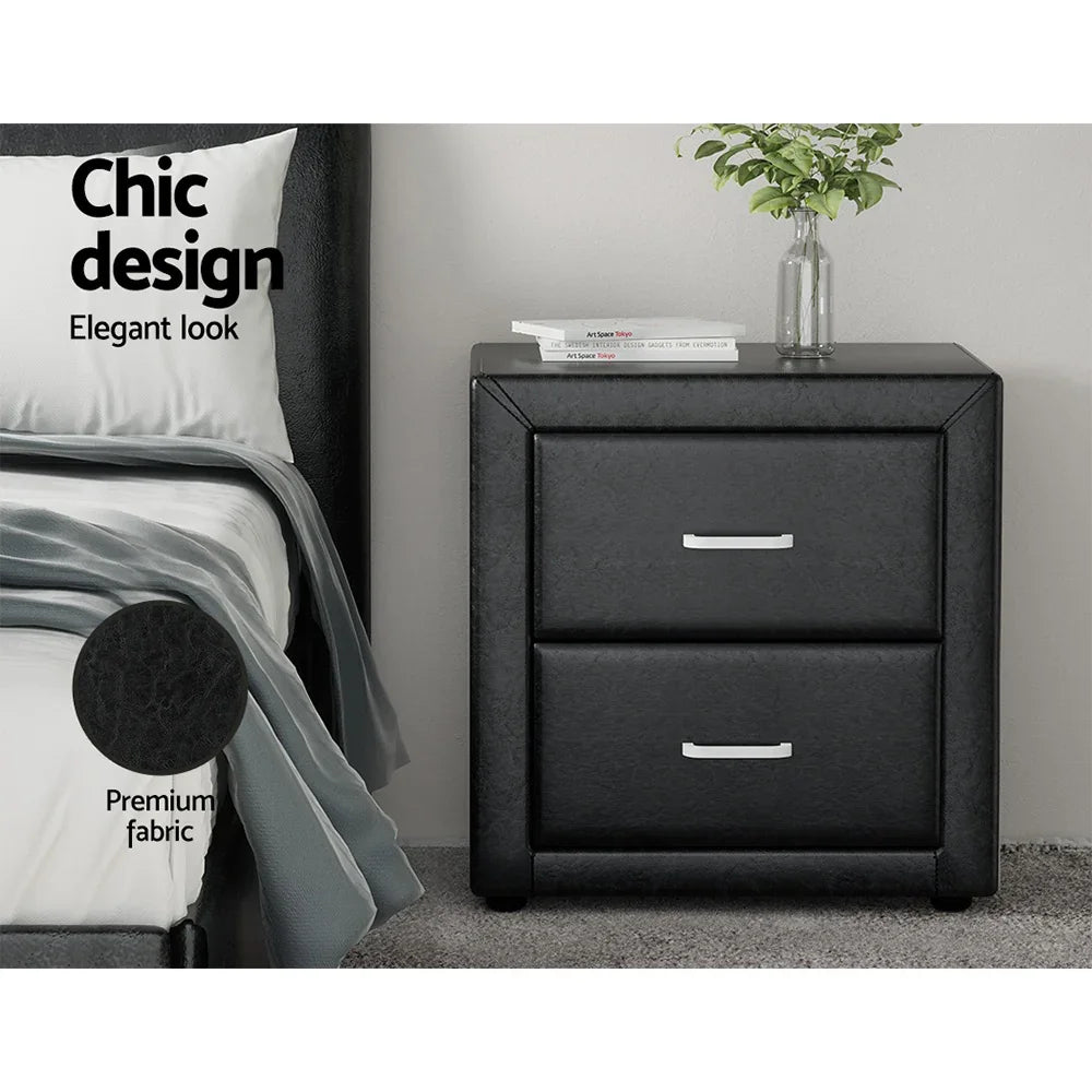 Black faux leather nightstand with two drawers, silver handles, and chic bedroom decor