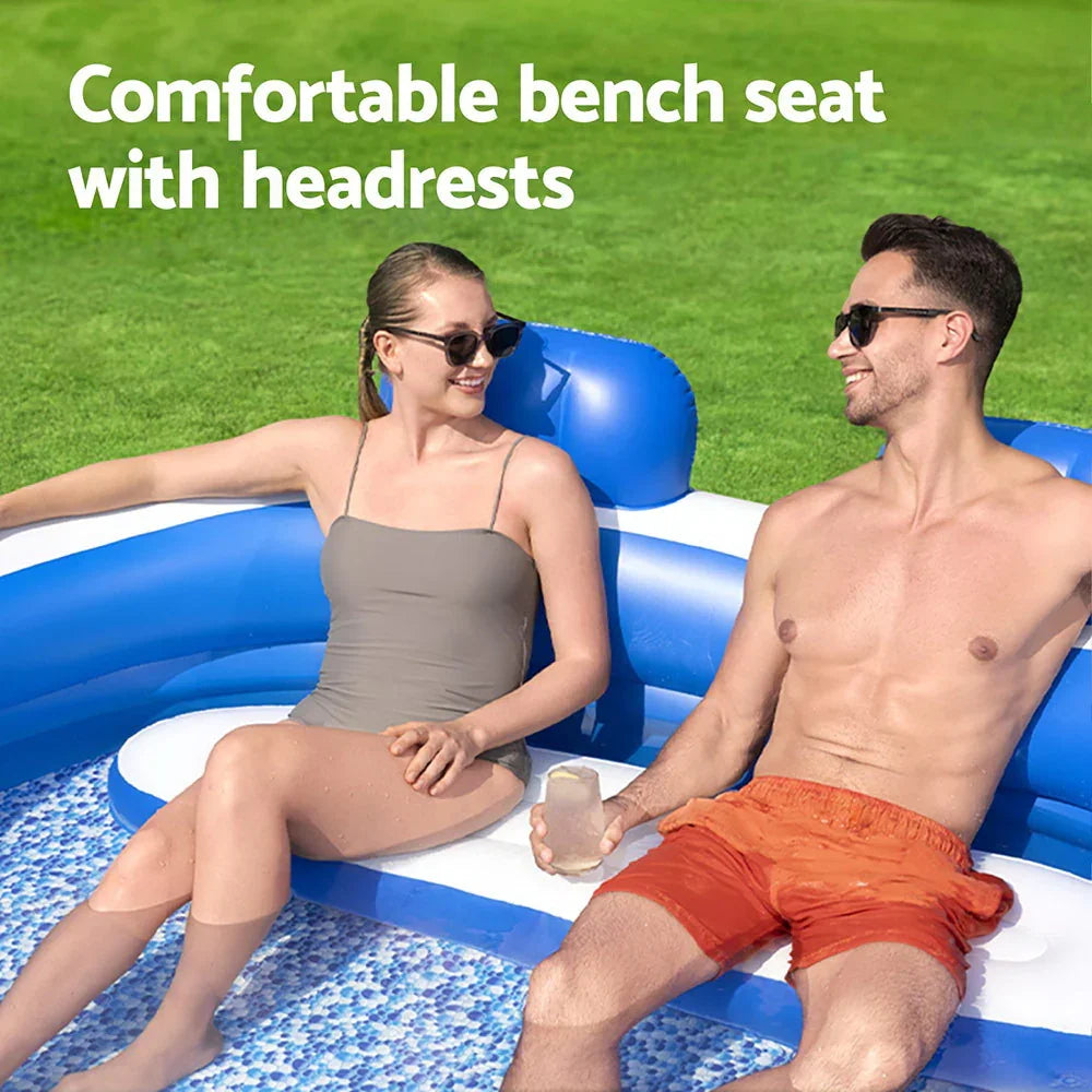 Man and woman relaxing on inflatable blue and white pool bench seat with headrests in outdoor pool