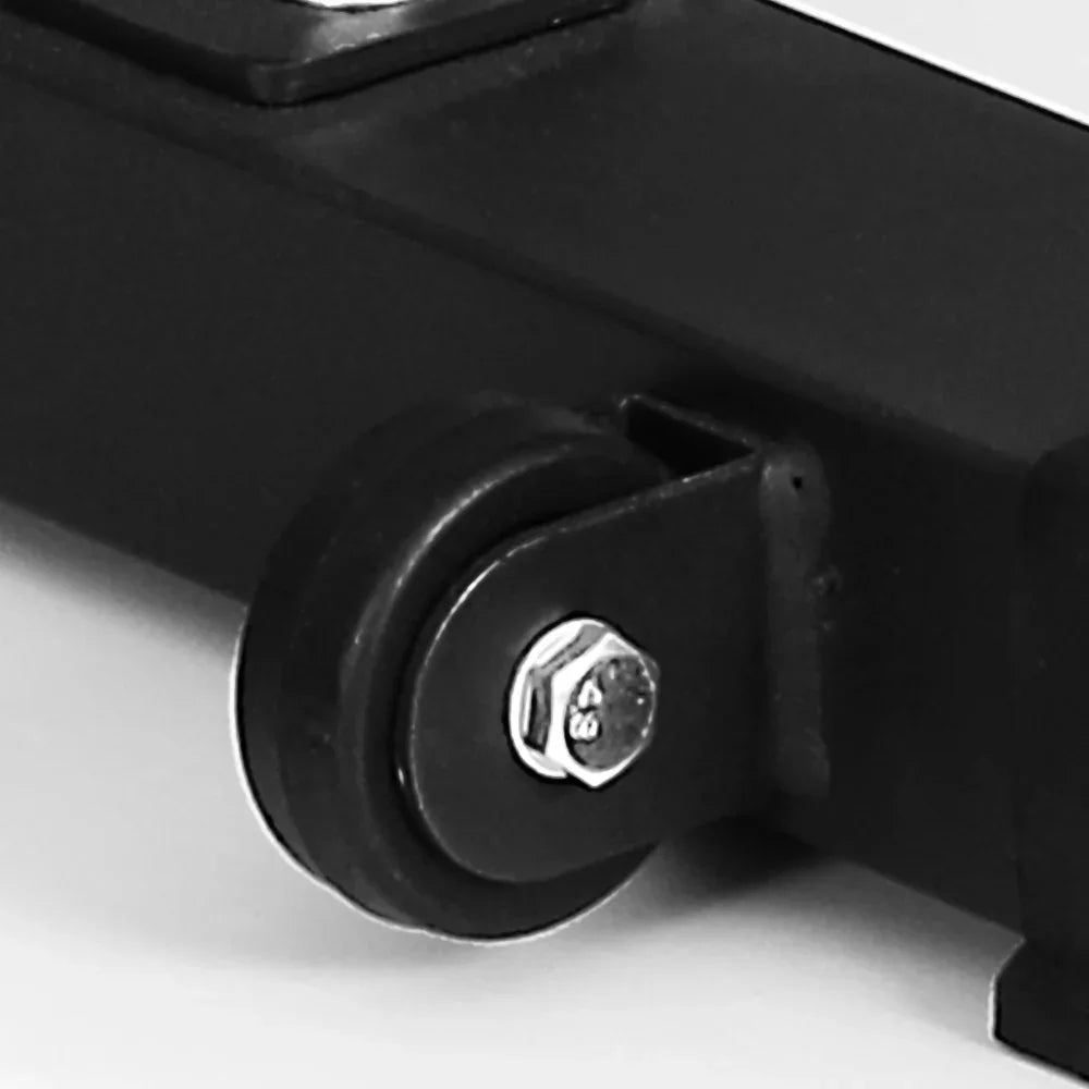 Close-up of black caster wheel attached to metal frame with bolt and nut