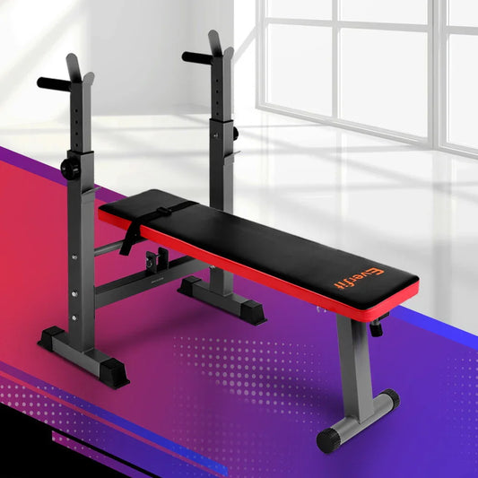 Adjustable workout bench with black and red padding in a modern gym setting