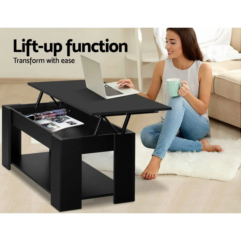 Woman using black lift-up coffee table desk with laptop in modern living room
