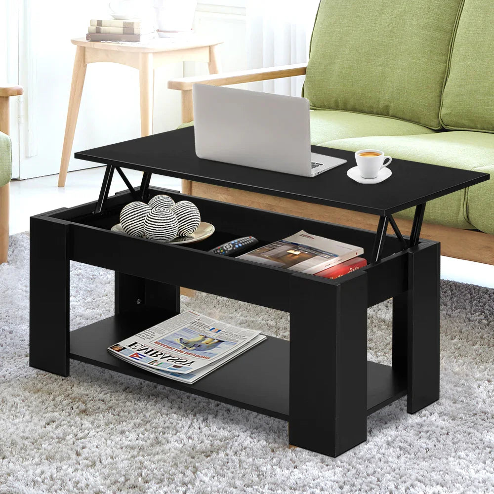 Modern black lift-top coffee table with laptop and cup in a bright living room