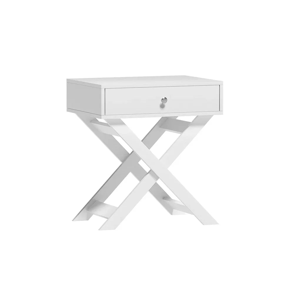 Modern white nightstand with single drawer and crossed legs, isolated on white background