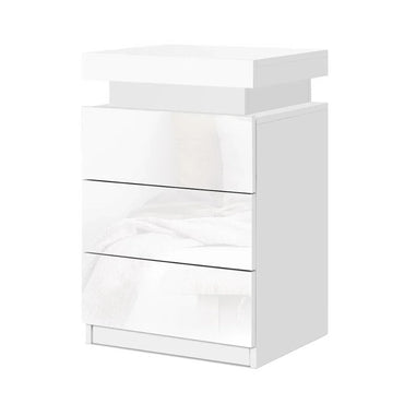 Modern white bedside table with three glossy drawers and minimalist design