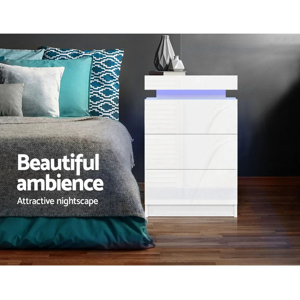 Modern white LED bedside table with blue accent in stylish bedroom with patterned pillows