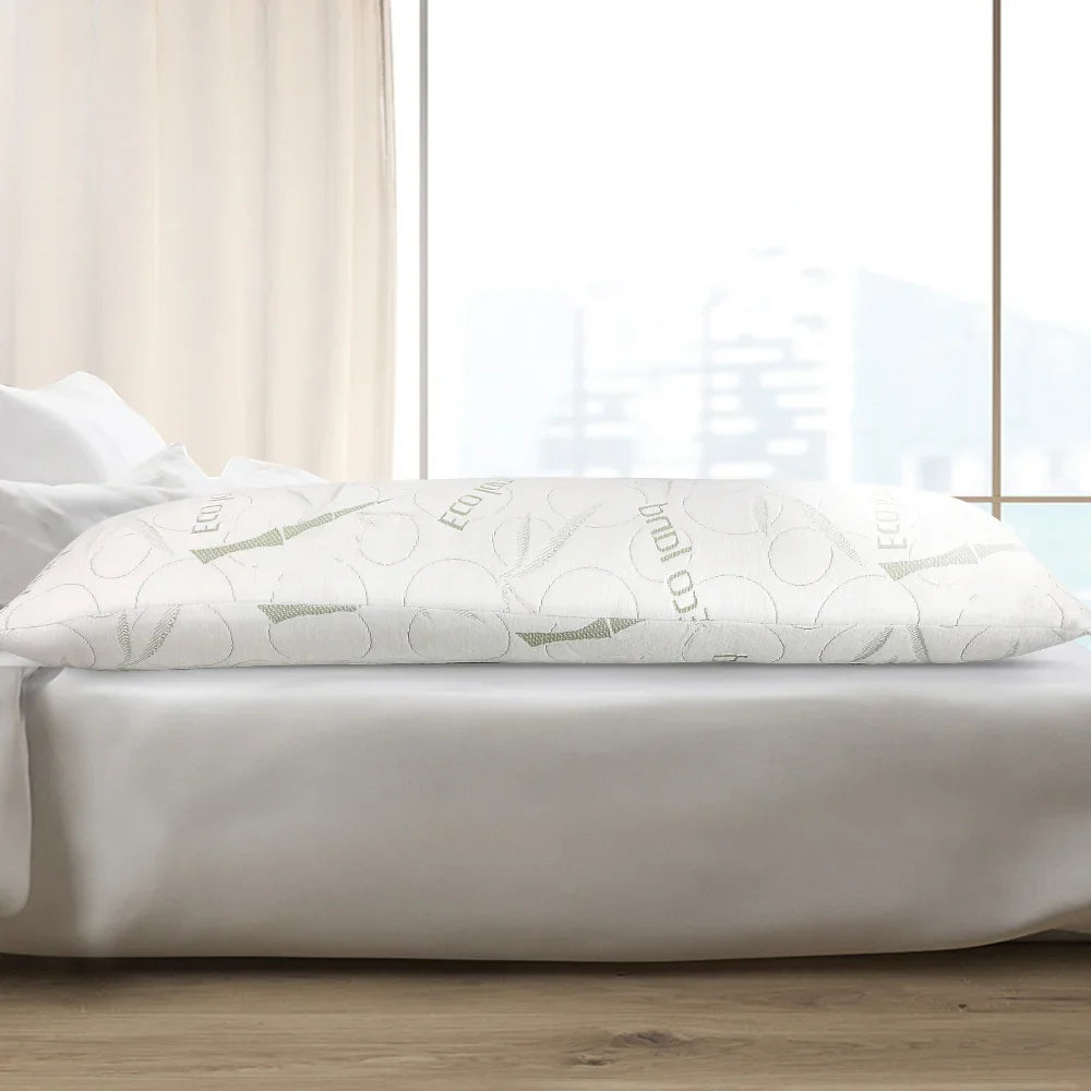 Eco-friendly white body pillow with bamboo design on bed with white sheets near window