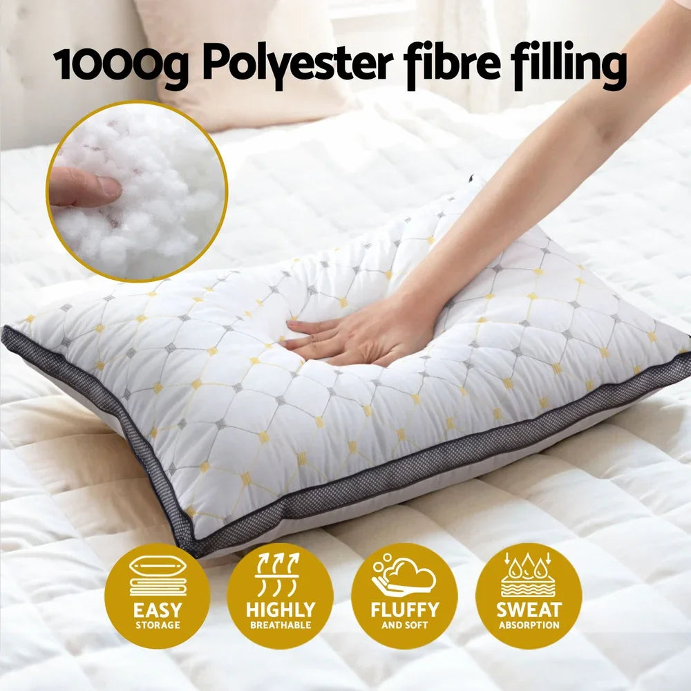 Hand pressing soft white pillow with polyester fiber filling on bed, highlighting breathability and sweat absorption
