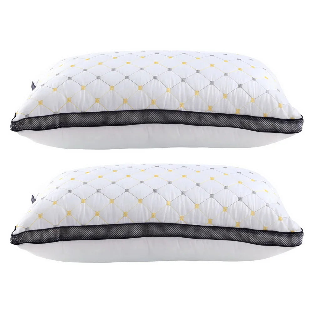 Two white pillows with black mesh trim and yellow-gray diamond pattern stacked side by side