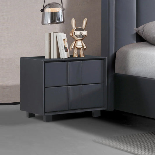 Modern black nightstand with books, gold bunny figurine, and pendant lamp beside bed