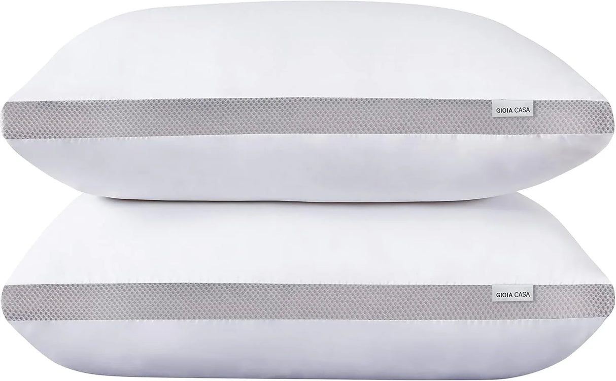 Two white rectangular pillows with breathable gray mesh sides and Gioia Casa labels stacked on white background