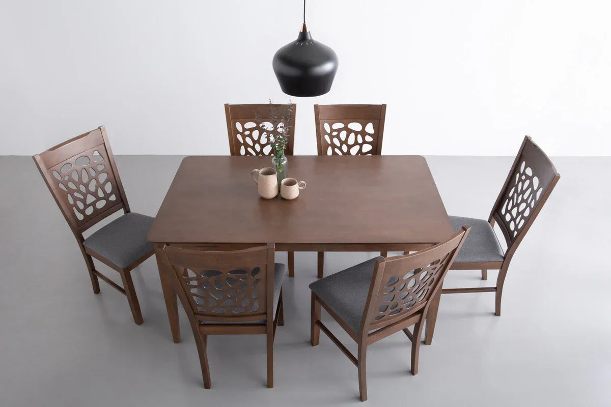 Modern wooden dining table set with six chairs, gray seats, black pendant lamp, and mugs
