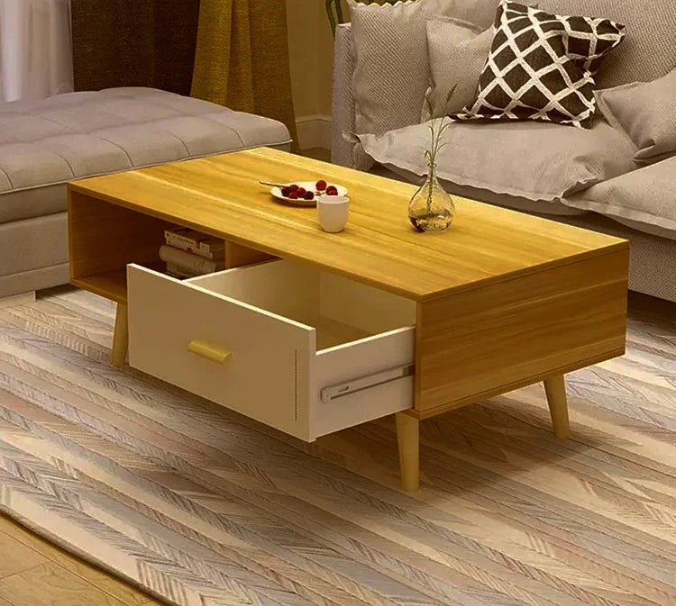 Modern wooden coffee table with open drawer, books, and decor in a cozy living room