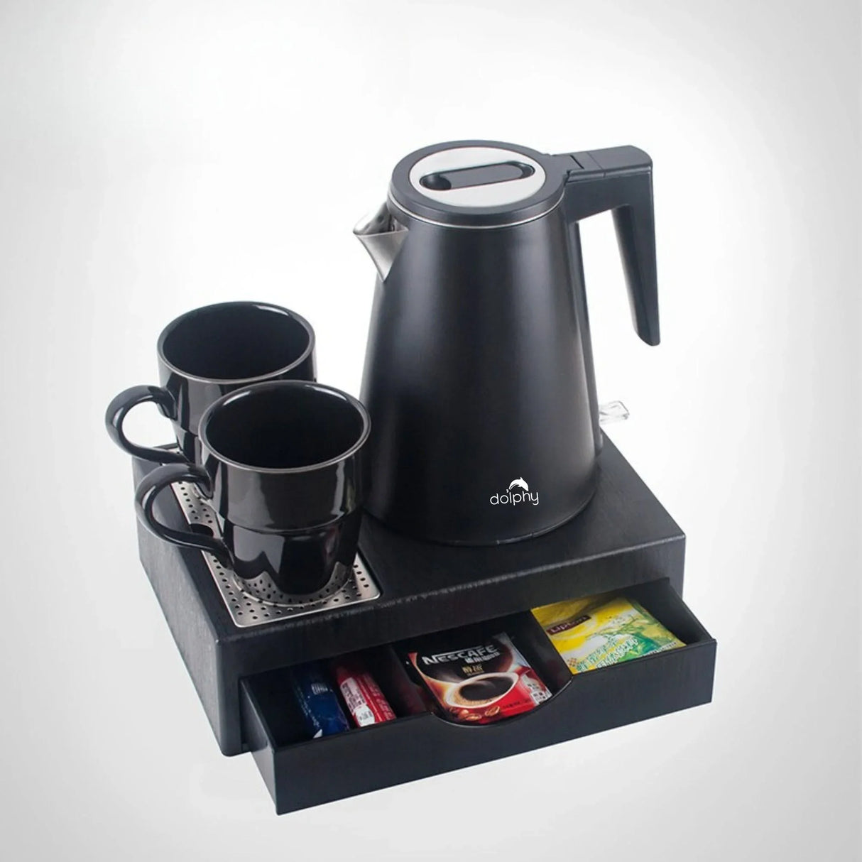 Black electric kettle with two black mugs on tray with drawer holding coffee and tea packets