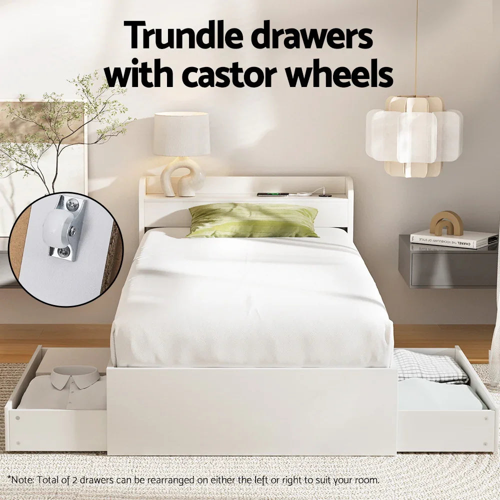 White modern single bed with green pillow and trundle drawers with castor wheels in bright bedroom