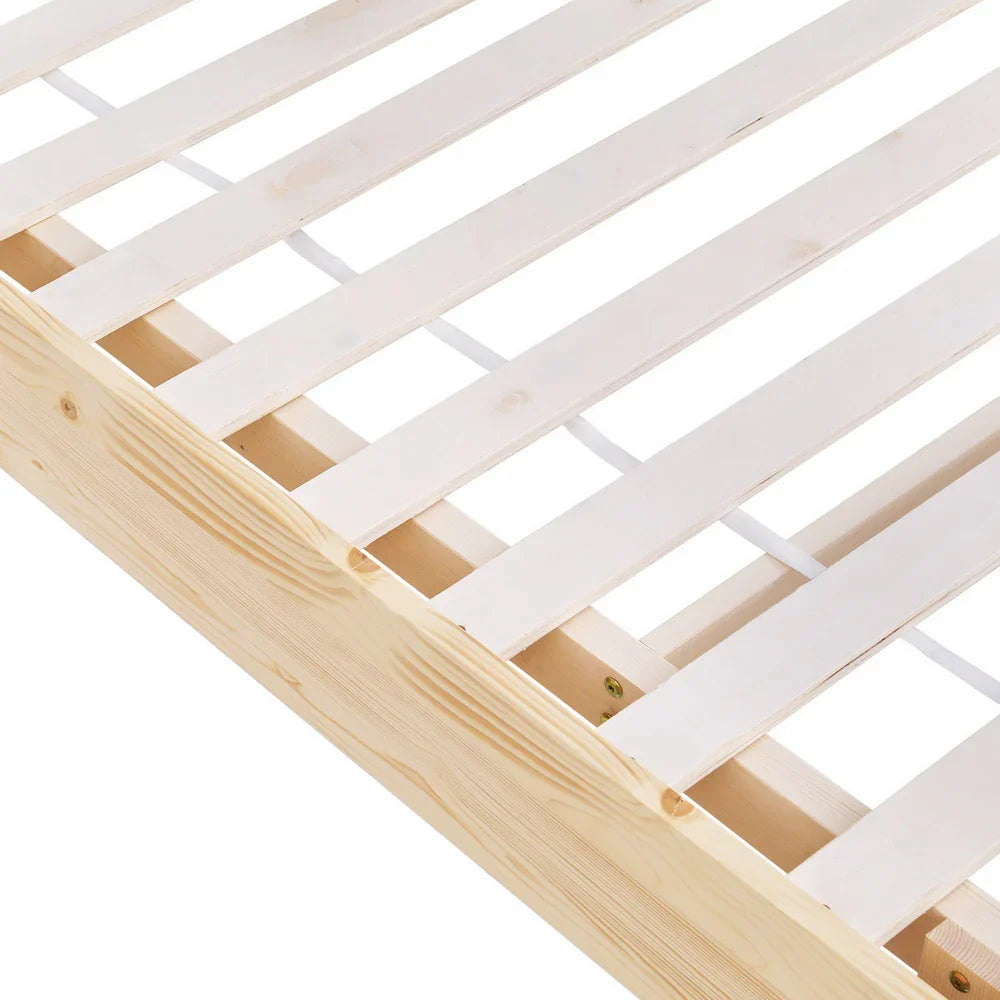 Close-up of natural wood bed frame with evenly spaced wooden slats and clear finish