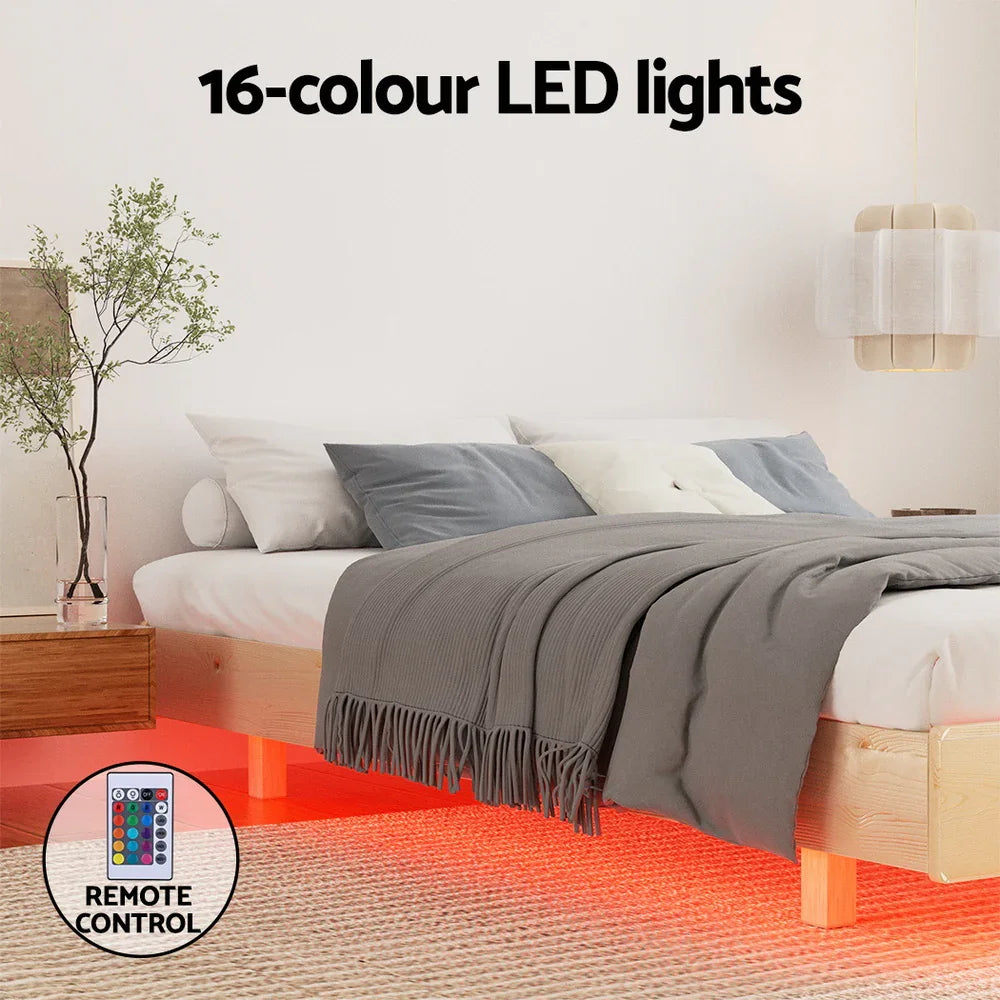 Modern bedroom with wooden bed featuring red 16-color LED lights underbed and remote control