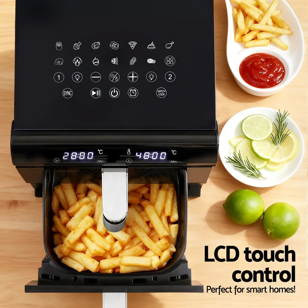 Black air fryer with LCD touch screen, fries in basket, sliced lemons, and dipping sauce