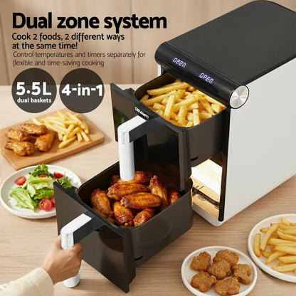 Dual zone air fryer with open baskets cooking fries and chicken wings, surrounded by food plates.