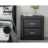 Black faux leather nightstand with two drawers, silver handles, and chic bedroom decor