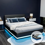 Modern black platform bed with blue LED lighting, gray bedding, and storage feature in stylish bedroom