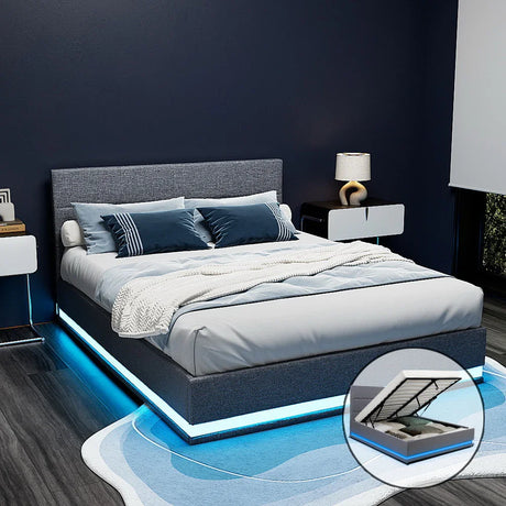 Modern gray fabric bed with blue LED lighting, blue pillows, white blanket, and nightstands in dark bedroom
