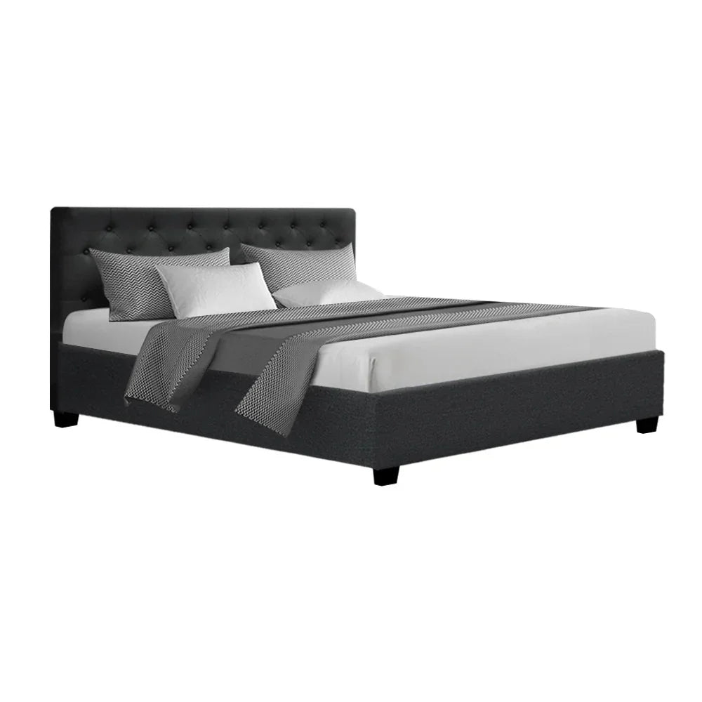 Modern black upholstered bed frame with tufted headboard and gray bedding