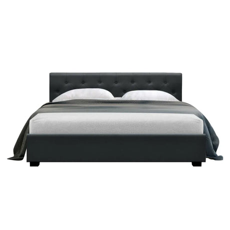 Modern dark gray upholstered bed with tufted headboard and white bedding on white background
