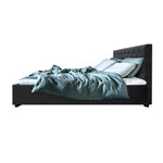 Modern dark gray upholstered bed with tufted headboard, light blue pillows, and teal bedding