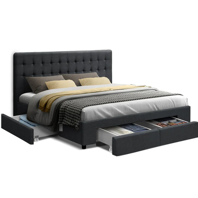 Modern dark gray upholstered bed with tufted headboard and under-bed storage drawers filled with clothes