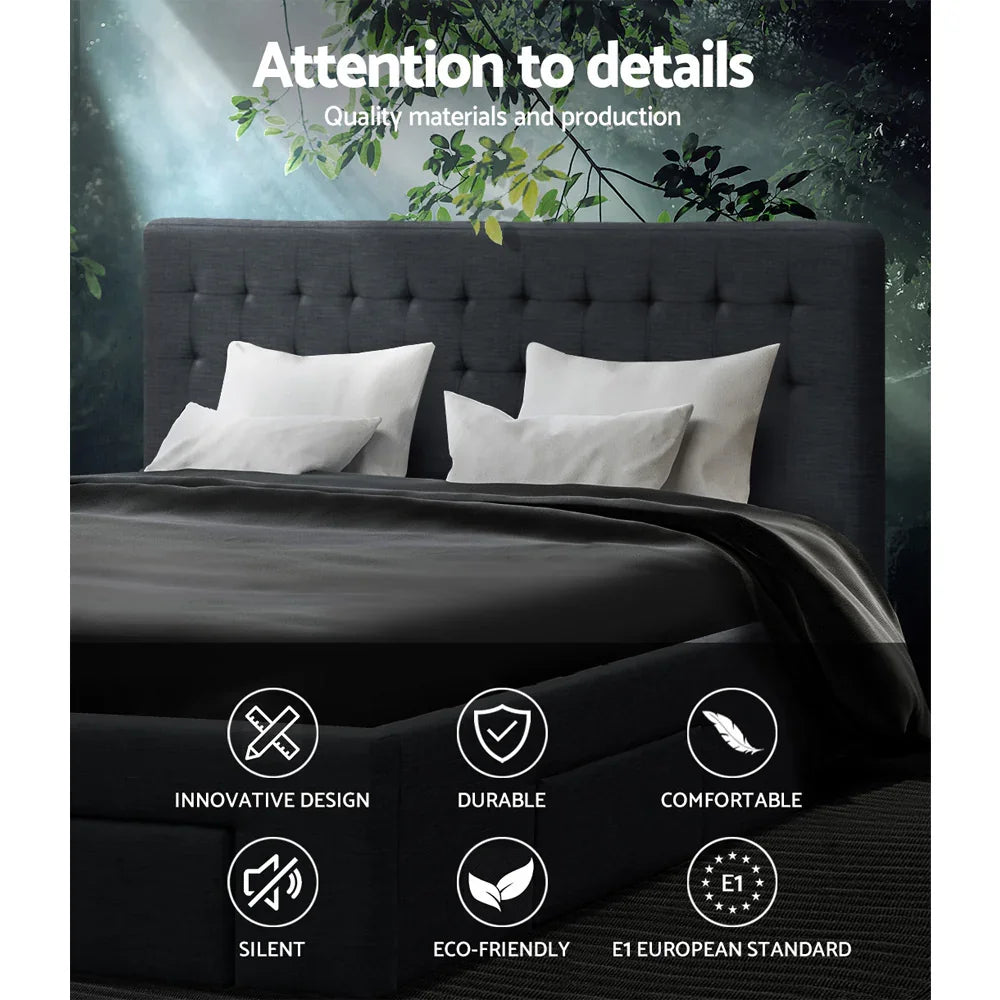 Dark gray upholstered bed with white pillows and black bedding under green leafy branches with quality and design icons