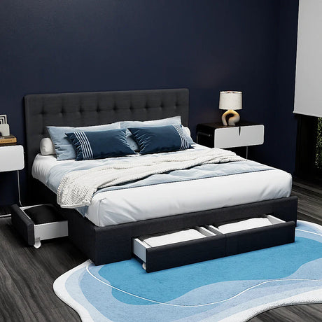 Modern bedroom with dark gray storage bed, blue and white bedding, geometric rug, and stylish bedside tables