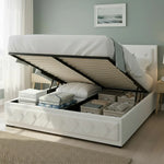 White upholstered storage bed with hydraulic lift, organized linens and boxes inside, in a modern bedroom