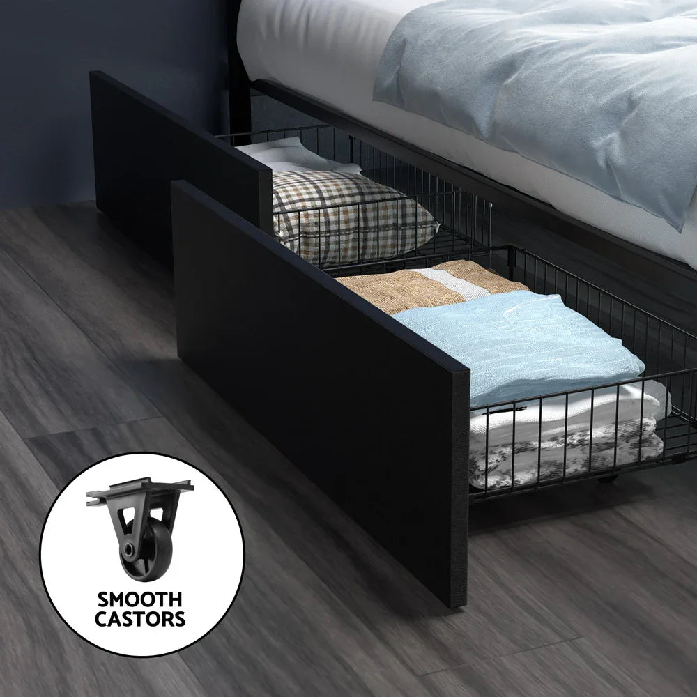 Black under-bed storage drawer with folded blankets and pillows on dark wooden floor
