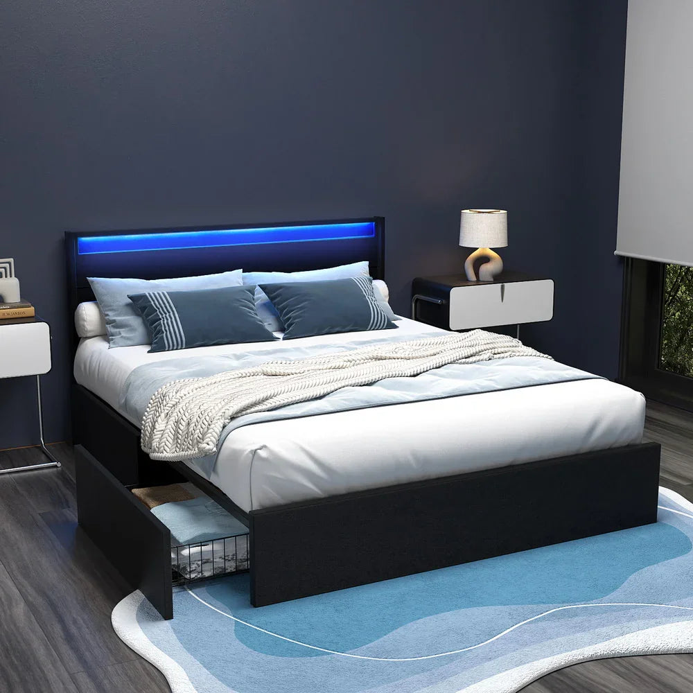 Modern bedroom with black platform bed featuring LED headboard, blue pillows, and under-bed storage drawer