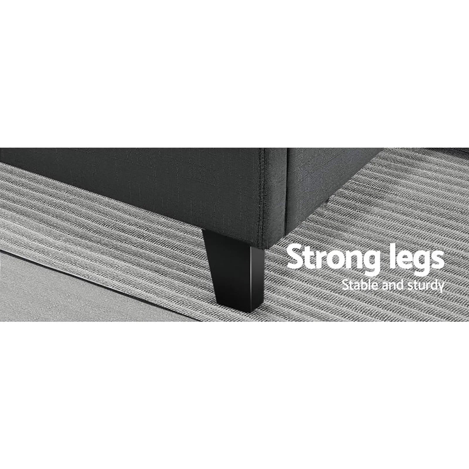 Close-up of black couch leg on striped gray rug highlighting strong, sturdy furniture support