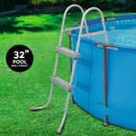 32-inch wall height blue above ground pool with gray safety ladder on green grass