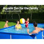 Family enjoying aquatic fun in backyard with blue above-ground swimming pool and beach ball