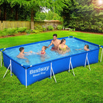 Family enjoying outdoor swimming in a blue Bestway Steel Pro rectangular above ground pool on green grass