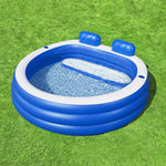 Blue and white inflatable kiddie pool with built-in backrests on green grass