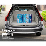 Open car trunk with boxed bestway private pool on driveway in suburban setting
