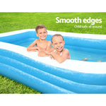 Two smiling children in a blue inflatable pool on green grass with text about smooth, child-safe edges