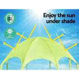 Green outdoor canopy tent under bright sun with UV protection and 40+ UPF shield icons