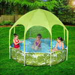 Children playing in a small outdoor pool with green leaf print sides and a light green canopy