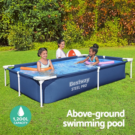 Two girls playing in a Bestway Steel Pro above-ground pool with water noodles and an adult nearby in a green backyard