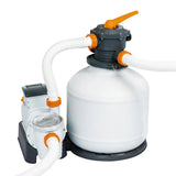 White and gray sand filter pump with orange valves and white hoses for pool water filtration