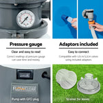 Flowclear pool pump with pressure gauge, blue valve adaptors, and leaf strainers on grass