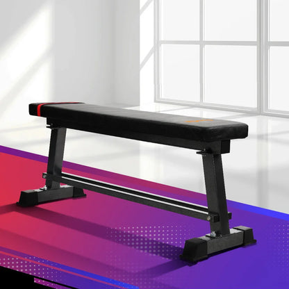 Flat workout bench in a bright gym with modern geometric flooring
