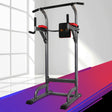 black and grey power tower pull-up and dip station with red cushions in bright gym room