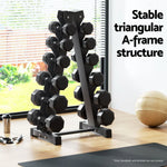 Black metal A-frame dumbbell rack with multiple hex dumbbells in a bright home gym