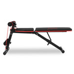 Black and red adjustable workout bench with resistance bands and foam rollers for home gym